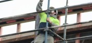 A construction worker on scaffolding. 