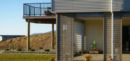 The side of a house looking at a deck. 