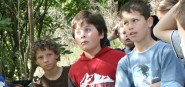 Children standing and listening to an outdoor envi