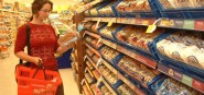 A woman shops for bread. 