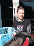 A woman putting out washing in the sun. 