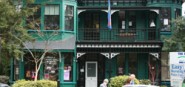 A green two storey house. 