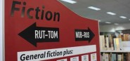 Fiction sign on side of bookshelf. 