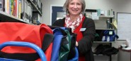Librarian pushing a blue cart. 