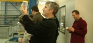 A man holding up a glass jar. 