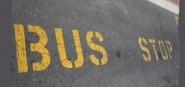 Bus stop sign on road. 