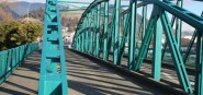 A green iron bridge. 