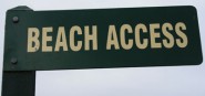 A green sign saying beach access. 