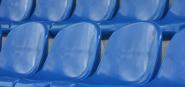Blue seats in the stands of Trafalgar Park. 