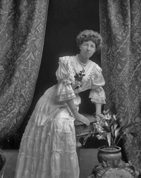 Black and white photo of Rosaline Frank standing in a dress. 