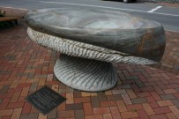 A stone sculpture on brick pavers.  
