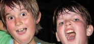 Two boys cheering at an event. 