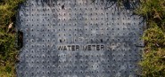 A black water meter cover. 